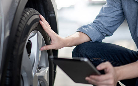 MINI Mechanic Inspecting Tire